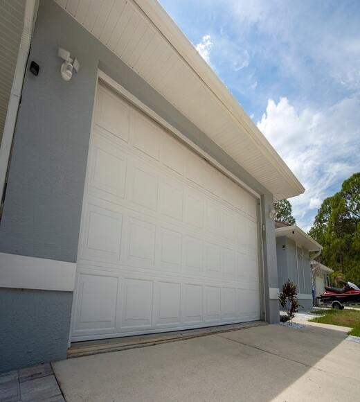 wide-garage-double-door-and-concrete-driveway-of-new-modern-american-house (1)